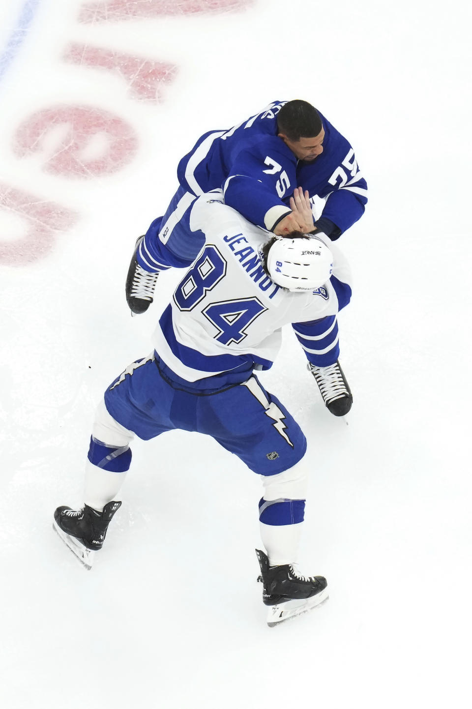 Toronto Maple Leafs' Ryan Reaves (75) and Tampa Bay Lightning's Tanner Jeannot (84) fight during the third period of an NHL hockey game Wednesday, April 3, 2024, in Toronto. (Chris Young/The Canadian Press via AP)