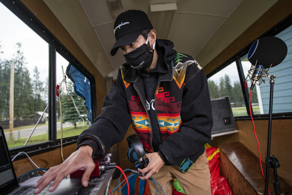 In this photo taken June 16, 2020, Artie Mendoza III, also known as KiidTruth, works on a new track in his home studio in Pablo, Montana. Mendoza created a viral TIk Tok dance and song to promote hand washing, mask wearing and social distancing among the youth on the Flathead Indian Reservation. (AP Photo/Tommy Martino)