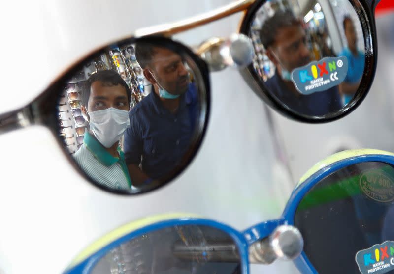 Migrant workers from Bangladesh shop for sunglasses in Singapore