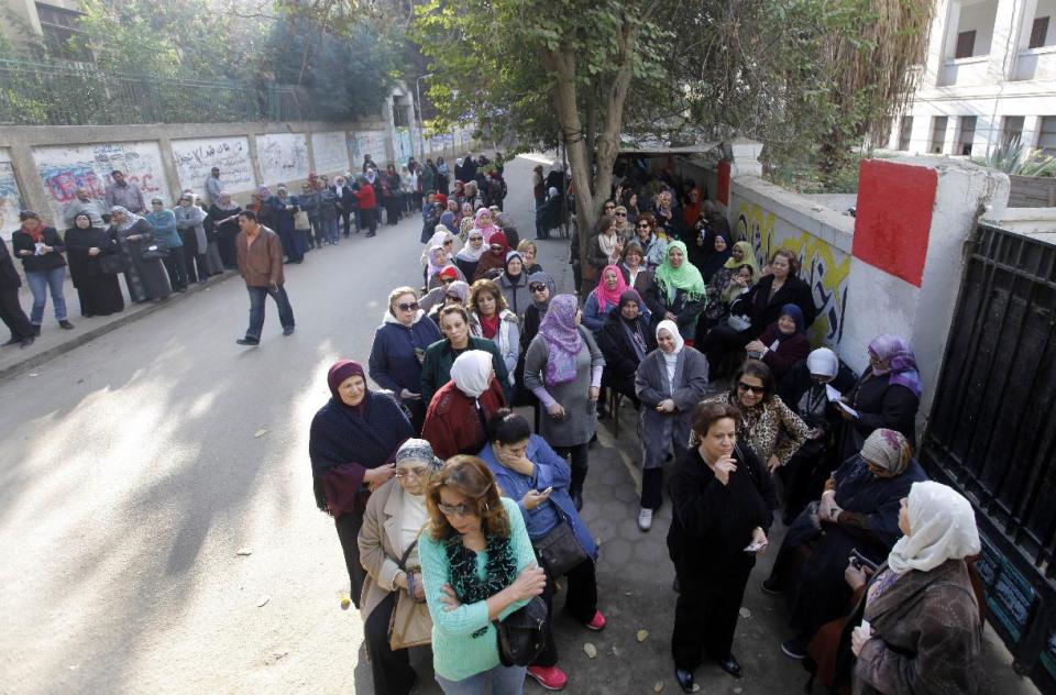 Egyptian voters line up outside a polling station in Cairo, Egypt, Tuesday, Jan. 14, 2014. Egyptians are voting on a draft for their country's new constitution that represents a key milestone in a military-backed roadmap put in place after President Mohammed Morsi was overthrown in a popularly backed coup last July. (AP Photo/Amr Nabil)