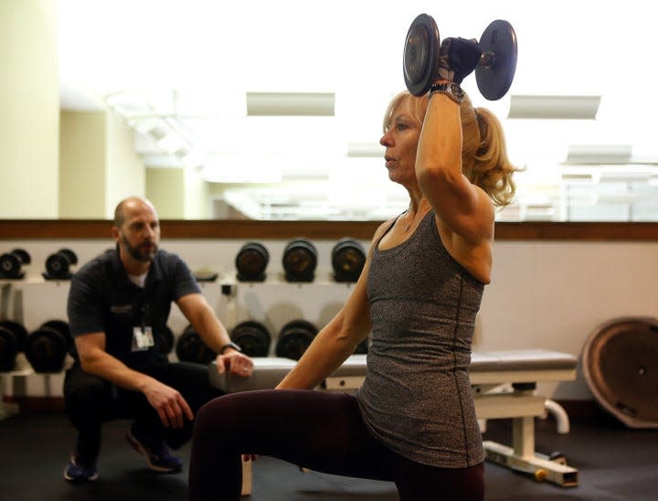 Personal trainer Scott Crabiel works with Myriam Haslinger of Bath at Cleveland Clinic Akron General Health and Wellness Center