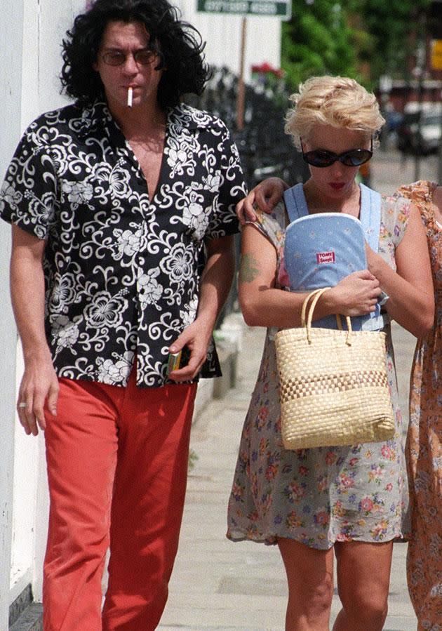 Tiger's mother, Paula Yates, cradles her in a baby carrier as she walks with her daughter's father Michael Hutchence. Source Getty