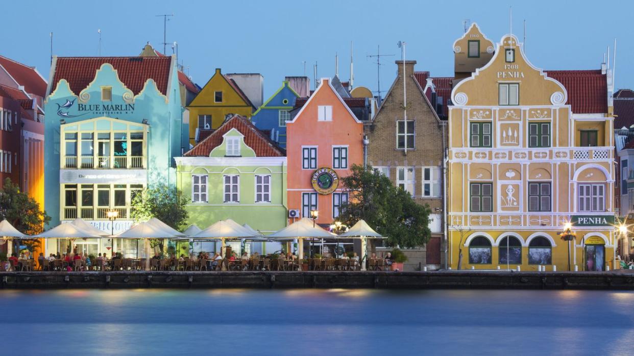 traditional multi colored town houses on waterfront at dusk, punda, willemstad, curacao, caribbean