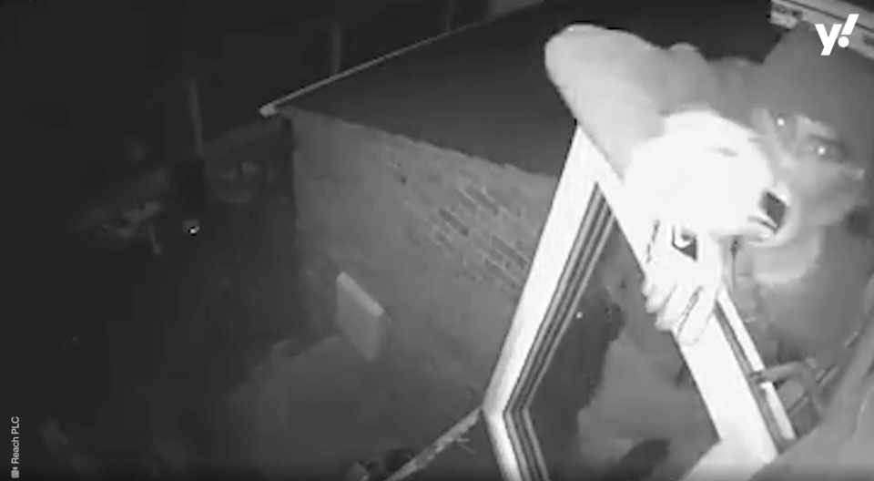 One of the burglars notices the camera. (Reach)