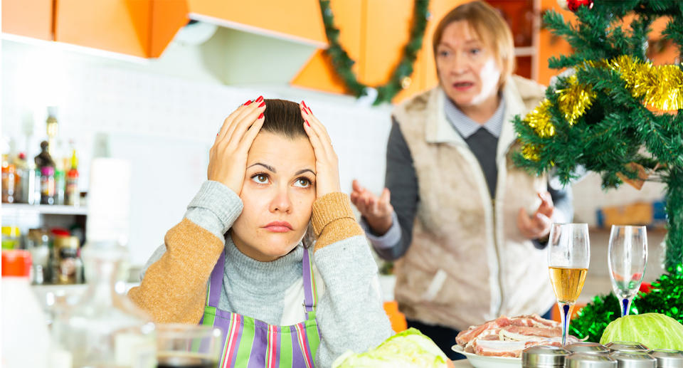 Mother and daughter having Christmas family argument in kitchen. (Getty Images)