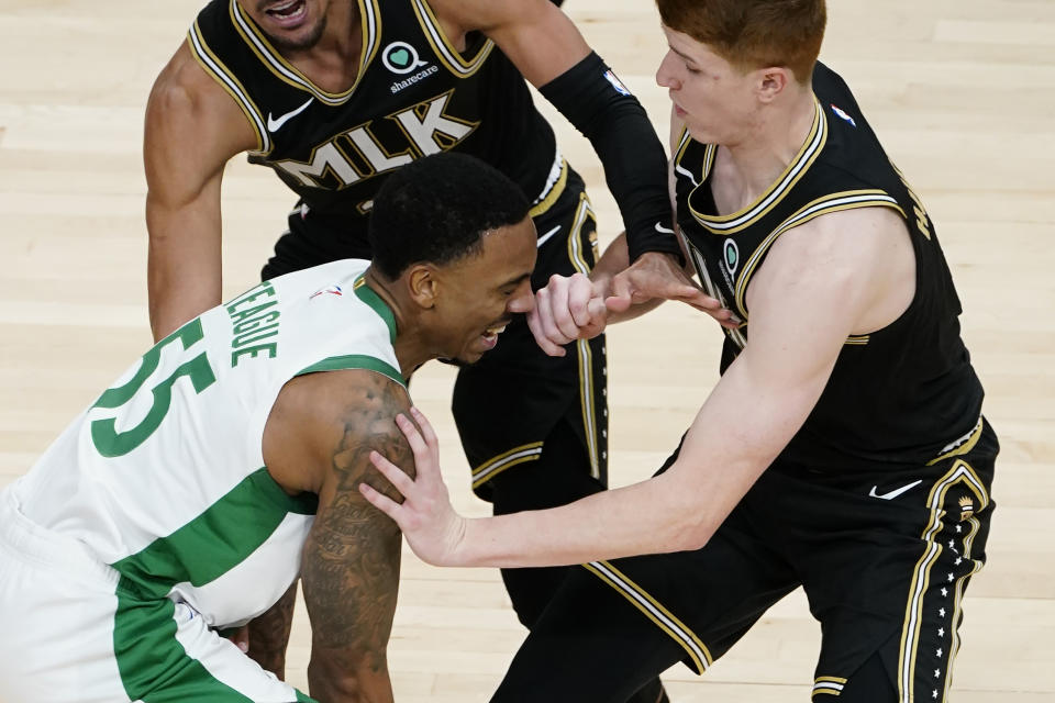 Boston Celtics guard Jeff Teague (55) is fouled by Atlanta Hawks guard Kevin Huerter (3) in the second half of an NBA basketball game Wednesday, Feb. 24, 2021, in Atlanta. (AP Photo/John Bazemore)