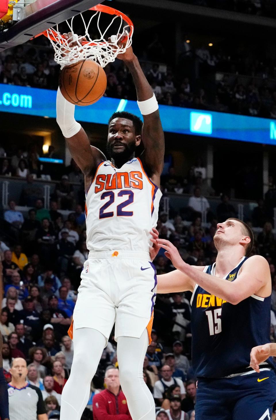 Phoenix Suns center Deandre Ayton (22) slam-dunks the ball over Denver Nuggets center Nikola Jokic (15) in the first half during Game 2 of the Western Conference Semifinals at Ball Arena in Denver on May 1, 2023.