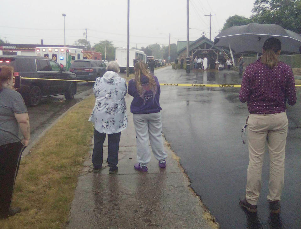 This photo provided by Thomas Coleman shows people watching as people are rescued after a boat capsized Monday, June 12, 2023, during a tour of an underground cavern system built to carry water from the Erie Canal beneath the western New York city of Lockport, police said. (Thomas Coleman via AP)