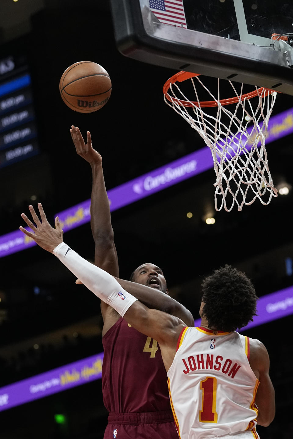 Cleveland Cavaliers forward Evan Mobley (4) shoots over Atlanta Hawks forward Jalen Johnson (1) during the first half of a preseason NBA basketball Tuesday, Oct. 10, 2023, in Atlanta. (AP Photo/John Bazemore)