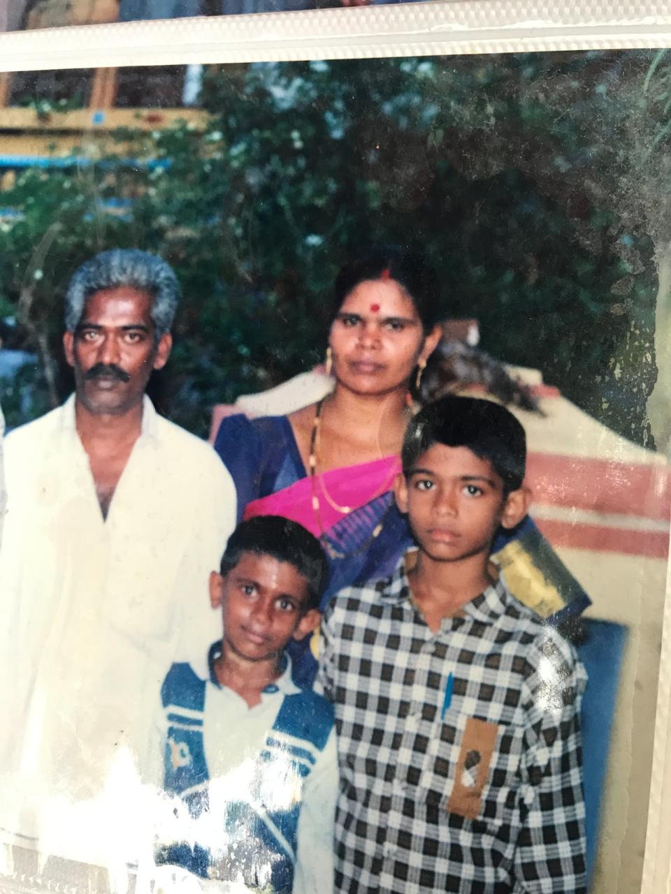 Nagaraj Hariharasuthan's family photo with his parents and his younger brother from a photo album.