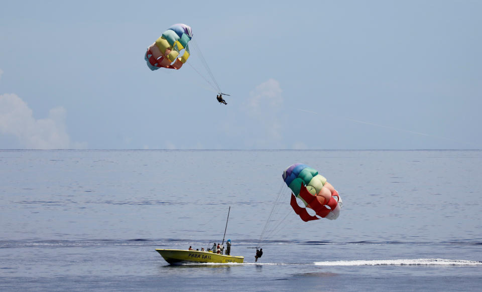 <p>Tourists take part in parasail off the waters of Tumon beach on the island of Guam, a U.S. Pacific Territory, August 10, 2017. (Erik De Castro/Reuters) </p>