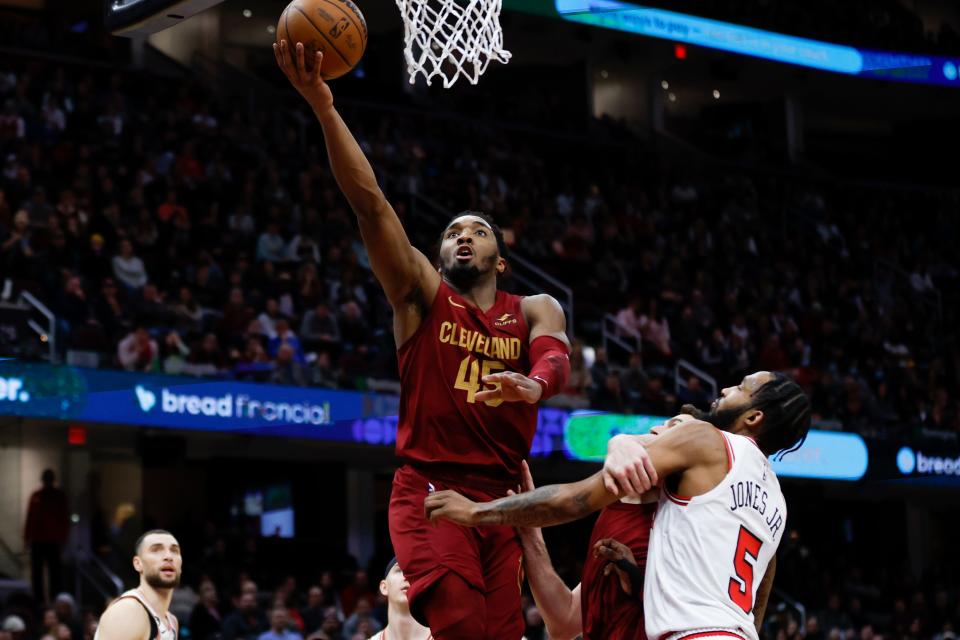 Cleveland Cavaliers guard Donovan Mitchell (45) shoots against Chicago Bulls forward Derrick Jones Jr. (5) during the second half of an NBA basketball game, Monday, Jan. 2, 2023, in Cleveland. (AP Photo/Ron Schwane)