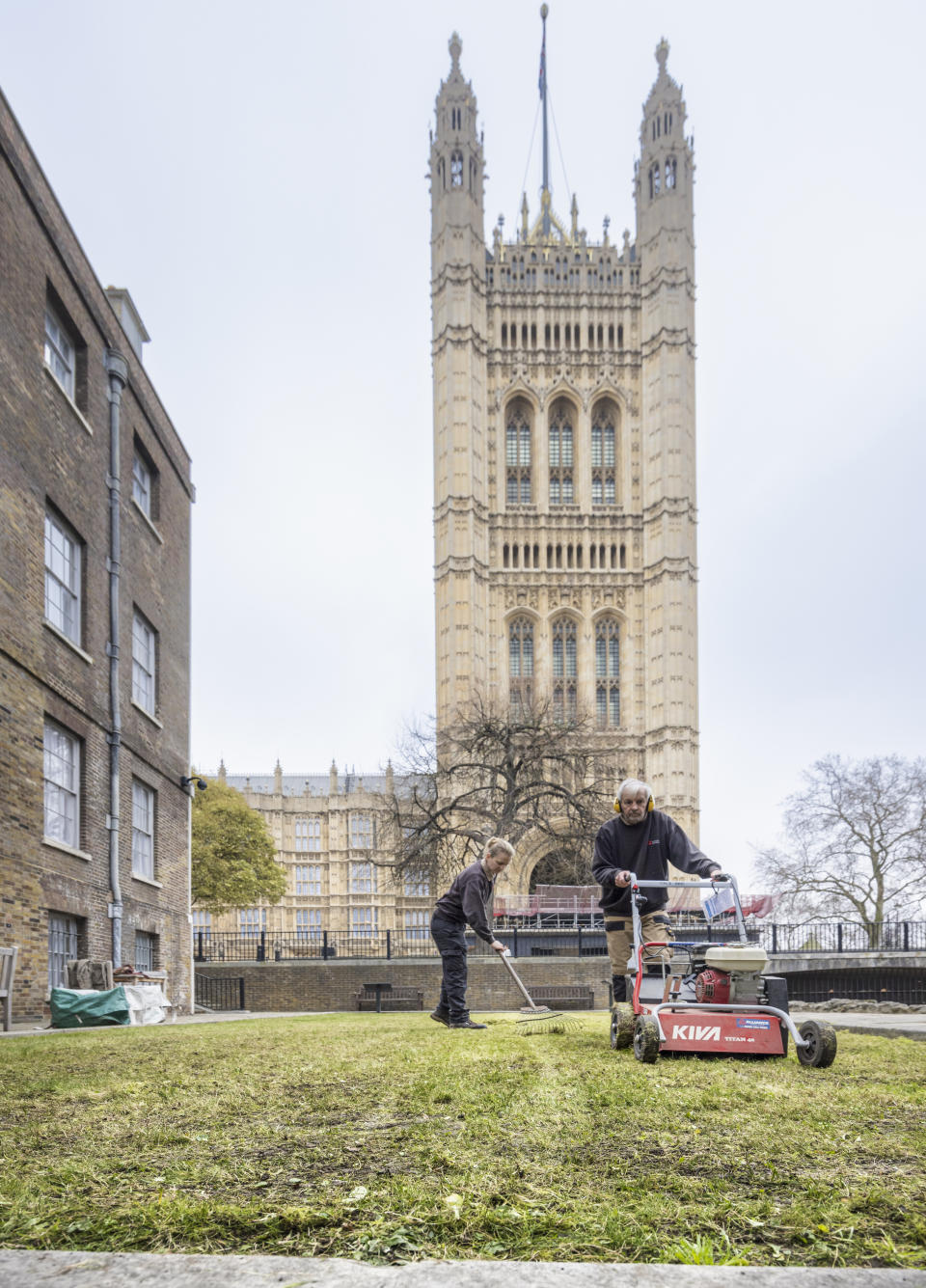 Gardeners prepare a lawn outside the Jewel Tower with the Palace of Westminster in the background (English Heritage/PA)
