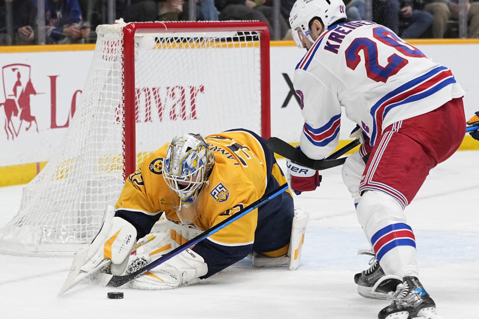 Nashville Predators goaltender Kevin Lankinen (32) defends the goal against the New York Rangers left wing Chris Kreider (20) during the third period of an NHL hockey game Saturday, Dec. 2, 2023, in Nashville, Tenn. The Rangers won 4-3. (AP Photo/George Walker IV)