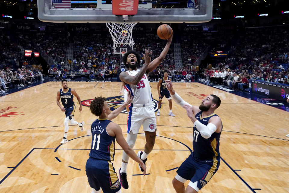 Detroit Pistons forward Marvin Bagley III (35) goes to the basket over New Orleans Pelicans guard Dyson Daniels (11) and center Jonas Valanciunas (17) in the first half of an NBA basketball game in New Orleans, Wednesday, Dec. 7, 2022. (AP Photo/Gerald Herbert)