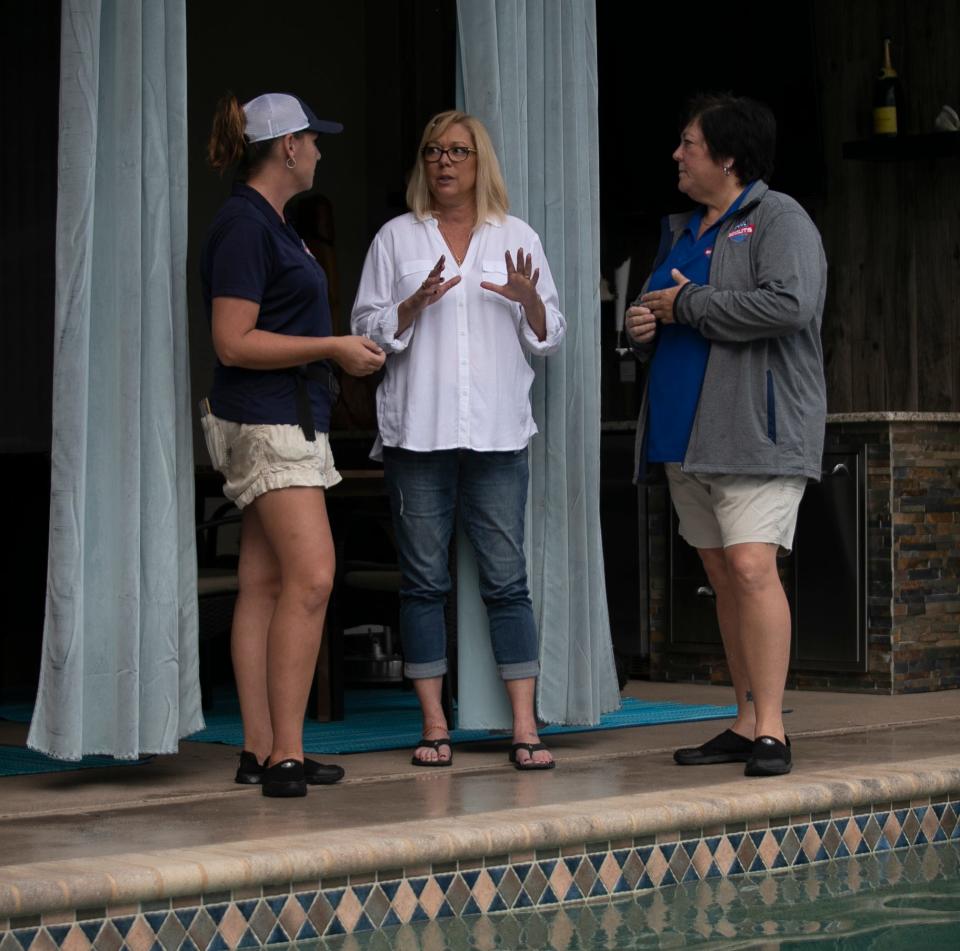 Pool owner Lisa Anthony, center, catches up with Pool Scouts co-owners Kate Richard, left, and Kristie Larsh after regular weekly servicing was done on her Cape Coral pool.