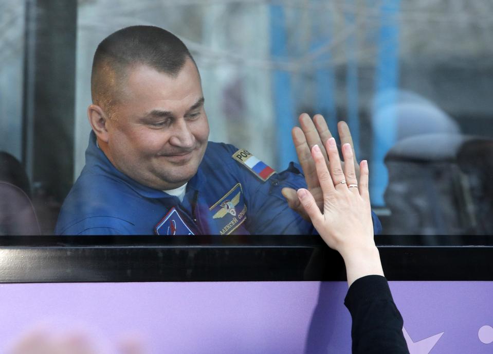 Russian cosmonaut Alexey Ovchinin, a members of the main crew to the International Space Station (ISS), interacts with his relative from a bus prior to the launch of the Soyuz FG rocket at the Russian leased Baikonur cosmodrome, Kazakhstan, Wednesday, March 13, 2019. The new Soyuz mission to the International Space Station (ISS) is scheduled on Thursday, March. 14. (AP Photo/Dmitri Lovetsky)