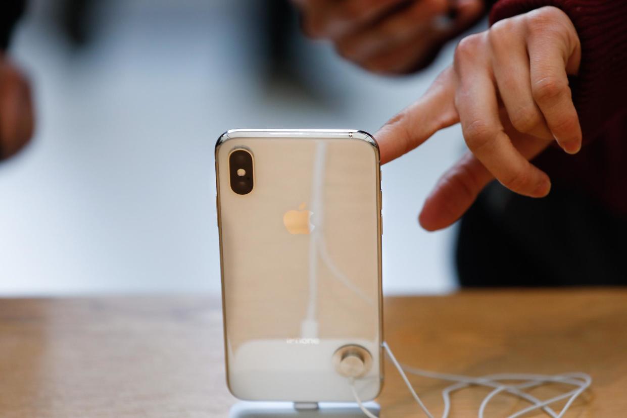 A customer touches the screen of the new iPhone X at the Apple Store Union Square on November 3, 2017, in San Francisco, California: ELIJAH NOUVELAGE/AFP/Getty Images