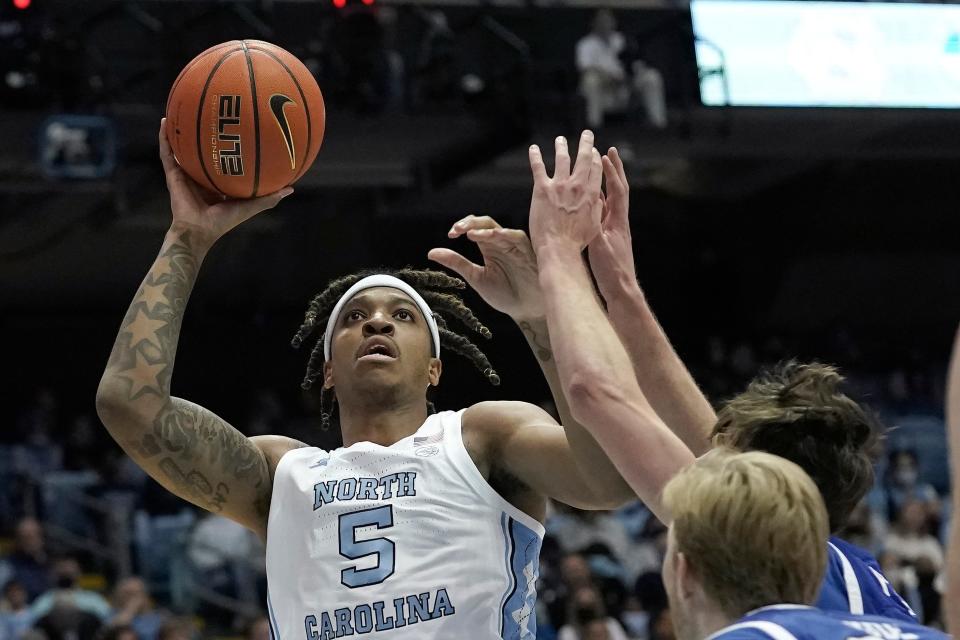 North Carolina forward Armando Bacot uses a post move to go up for a shot over UNC Asheville defenders during Tuesday night’s game at the Smith Center.