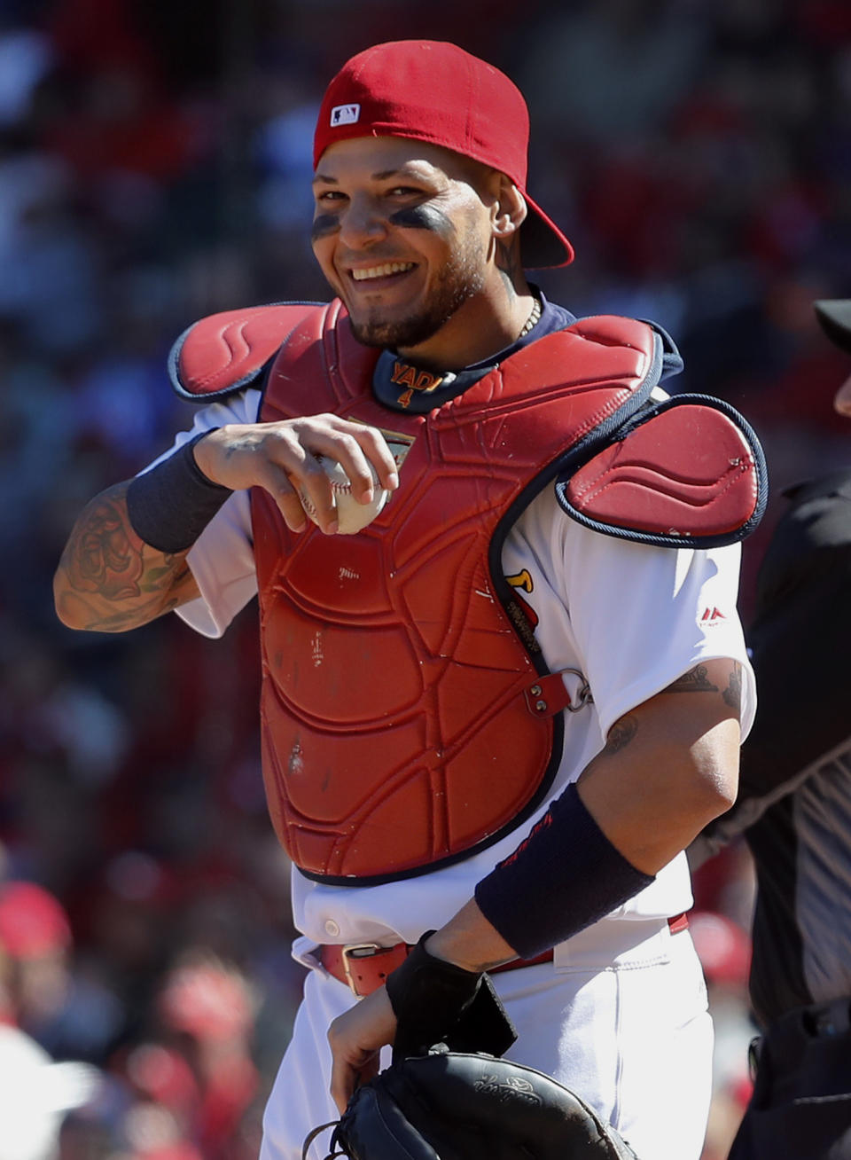 St. Louis Cardinals catcher Yadier Molina laughs after a ball somehow got stuck to his chest protector on a dropped third strike during the seventh inning of a baseball game against the Chicago Cubs on Thursday, April 6, 2017, in St. Louis. The ball was stuck to Molina's chest protector after the Cubs' Matt Szczur struck out swinging allowing Szczur to reach first base when Molina couldn't find the ball. (AP Photo/Jeff Roberson)