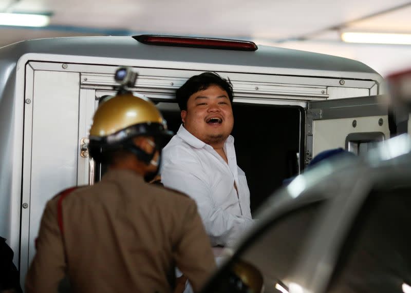 Parit Chiwarak, a pro-democracy student, one of the leaders of Thailand's recent anti-government protests, reacts as he is being send to the court, at the police station in Bangkok