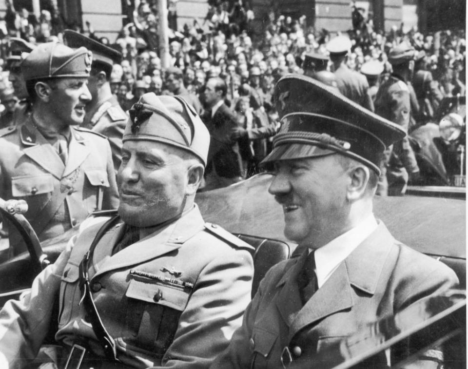 Adolf Hitler and Benito Mussolini riding in an open car, circa 1940s.<span class="copyright">Fotosearch/Getty Images</span>