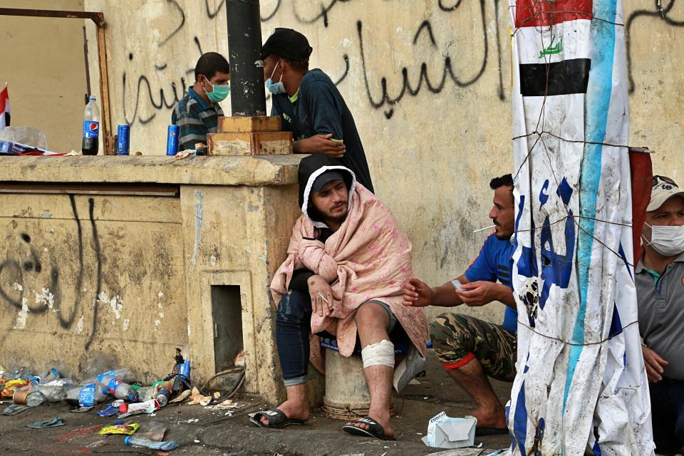 Anti-government protesters take a break during a demonstration in Tahrir Square, Baghdad, Iraq, Sunday, Oct. 27, 2019. Protests have resumed in Iraq after a wave of anti-government protests earlier this month were violently put down. At least 149 people were killed in a week of demonstrations earlier in October. (AP Photo/Hadi Mizban)