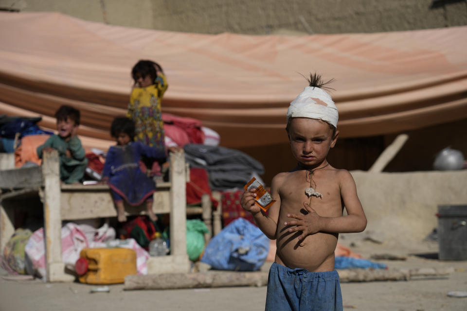 Injred boy stands in front of a makeshift shelter after an earthquake in Gayan village, in Paktika province, Afghanistan, Friday June 24, 2022. A powerful earthquake struck a rugged, mountainous region of eastern Afghanistan early Wednesday, flattening stone and mud-brick homes in the country's deadliest quake in two decades, the state-run news agency reported. (AP Photo/Ebrahim Nooroozi)