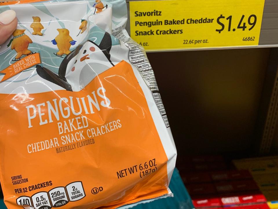 hand holding bag of aldi penguin crackers