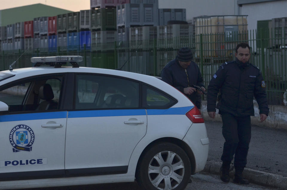 Police secure the area around a factory in the northern city of Komotini, about 800 kilometers (500 miles) northeast of Athens, Thursday, March 1, 2012. An unemployed man shot and wounded two people and took two others hostage at the plastics factory. The shooter, who was fired from the factory eight months ago, burst into the site with a with a shotgun, wounding a member of the management and another employee, police said. (AP Photo/Nikolas Giakoumidis)