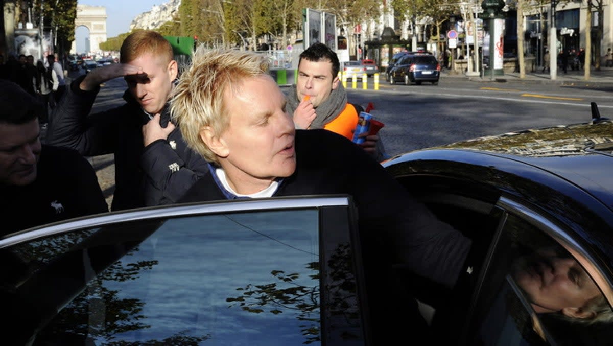 File image: Mike Jeffries, then-CEO of US clothing retailer Abercrombie & Fitch, leaves the store on the Champs Elysees avenue in Paris on 27 October 2012 (BERTRAND GUAY/AFP via Getty Images)