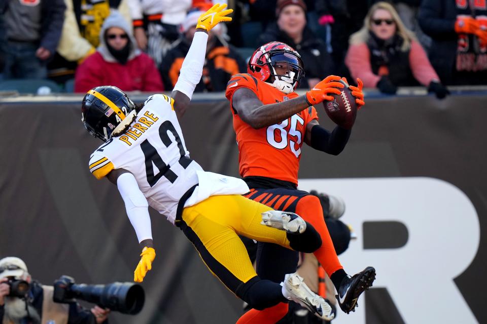 Cincinnati Bengals wide receiver Tee Higgins (85) catches a touchdown pass as Pittsburgh Steelers cornerback James Pierre (42) defends in the second quarter during a Week 12 NFL football game, Sunday, Nov. 28, 2021, at Paul Brown Stadium in Cincinnati. 