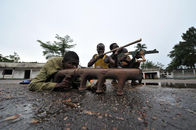 Members of the ex-Seleka rebels pose with their fake weapons at late Centrafrican emperor Jean-Bedel Bokassa's palace in Beringo, on March 3, 2014