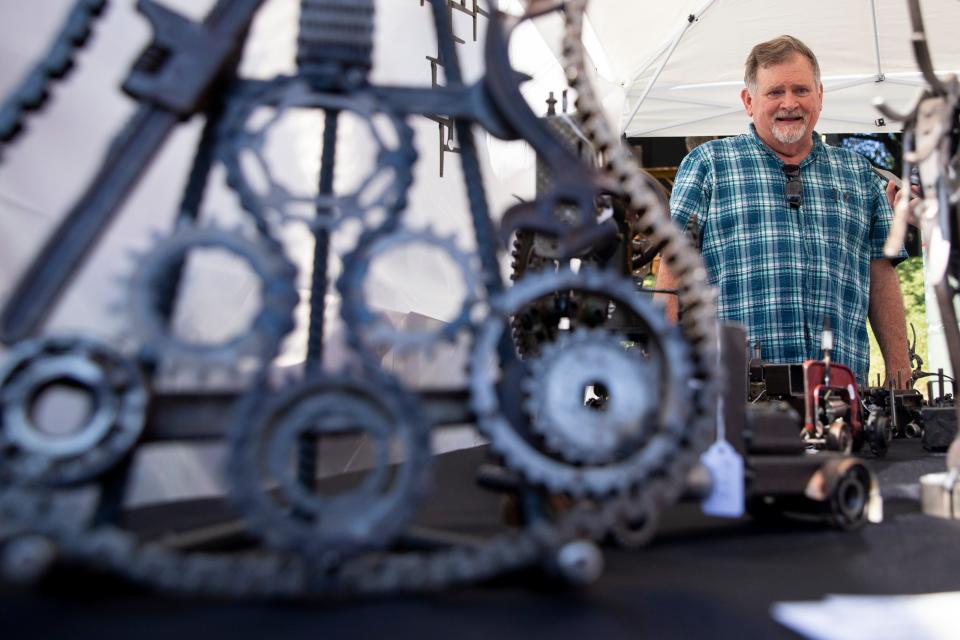 J.W. Burcham smiles as he talks about the designs he creates out of tools and pieces of machinery and metal during the Cooper-Young Festival in Midtown Memphis, on Saturday, September 16, 2023.