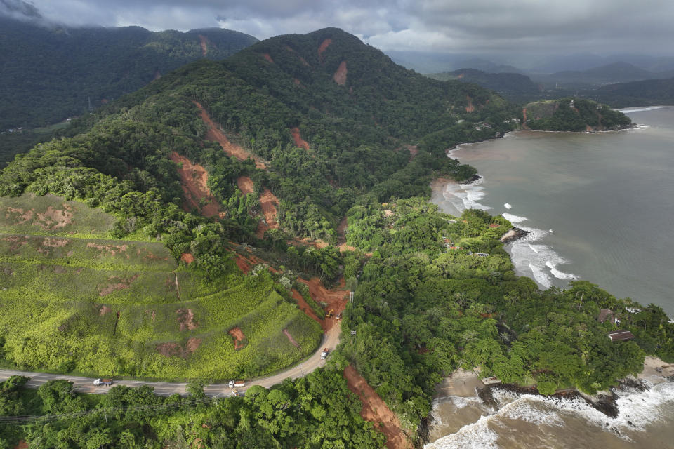 Aerial view of the Rio-Santos highway which connects the cities of Rio de Janeiro and Santos, blocked by a mudslide triggered by heavy rains, near the Barra do Sahi beach in the coastal city of Sao Sebastiao, Brazil, Monday, Feb. 20, 2023. (AP Photo/Andre Penner)