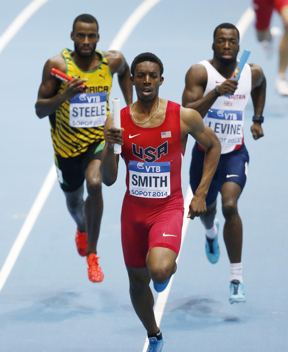 United States' Calvin Smith leads Jamaica's Edino Steele, left, and Britain's Nigel Levine to win the men's 4x400m relay final during the Athletics World Indoor Championships in Sopot, Poland, Sunday, March 9, 2014. (AP Photo/Petr David Josek)