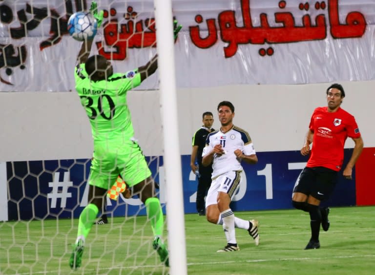 UAE Al-Wahda FC's Argentinian forward Sebastian Tagliabue (C) scores a goal against Qatar's Al-Rayyan SC goalkeeper Omar Bari (L) during their AFC Champions League group D football match at Al-Nahyan Stadium in Abu Dhabi on April 24, 2017