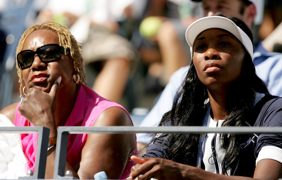 Venus Williams (R) and mother Oracene Williams (L), watch Serena Williams play against Lindsay Lee-Waters in the second round during the US Open September 1, 2004 at the USTA National Tennis Center in Flushing Meadows Corona Park in the Flushing neighborhood of the Queens borough of New York. (Photo by Al Bello/Getty Images)