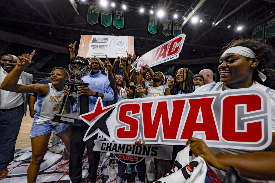 Southern players celebrate after clinching the championship by defeating Arkansas-Pine Bluff after an NCAA college basketball game in the championship of the Southwestern Athletic Conference Tournament, Saturday, March 11, 2023, in Birmingham, Ala. (AP Photo/Butch Dill)