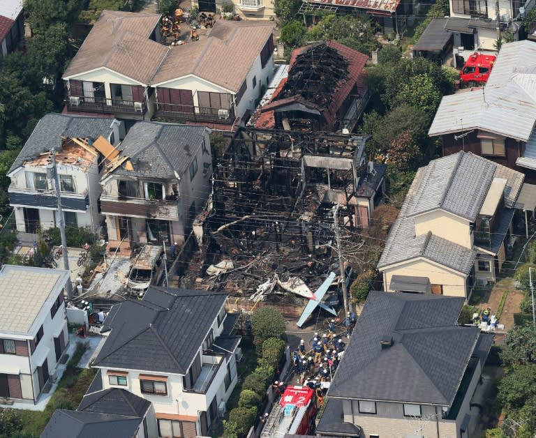 At least three houses and two cars caught fire when the plane crashed into the residential district of Chofu some 500 metres from Tokyo airport