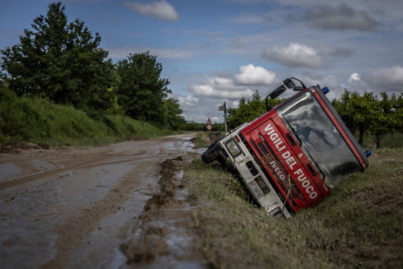 Photo of overturned firetruck beside road