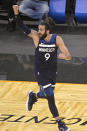 Minnesota Timberwolves guard Ricky Rubio reacts after scoring a 3-point basket during the second half of the team's NBA basketball game against the Orlando Magic, Sunday, May 9, 2021, in Orlando, Fla. (AP Photo/Phelan M. Ebenhack)