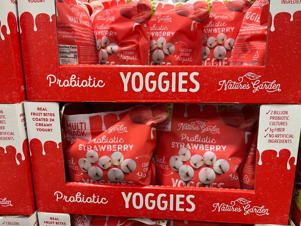 A Costco display of Nature's Garden probiotic Yoggies in large red bags on cardboard boxes