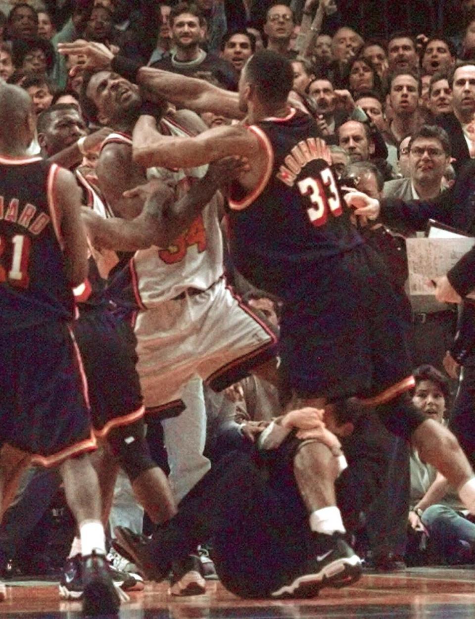 Alonzo Mourning, right, of the Miami Heat, and New York Knicks Charles Oakley grapple during a fight in the closing seconds of Game 4 of the first round playoff series Thursday, April 30, 1998, at Madison Square Garden in New York. Mourning was ejected from the game. Holding on to Mourning’s left leg is Knicks coach Jeff Van Gundy. The Knicks won 90-85 to force a fifth game. (AP Photo/Mark Lennihan)