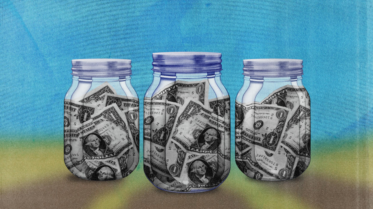 Three mason jars filled with paper money