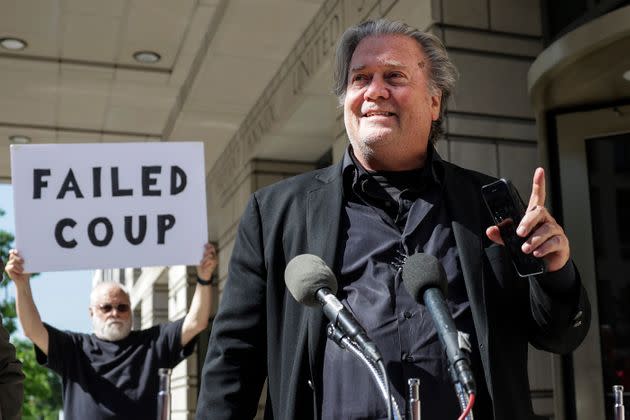 Steve Bannon, advisor to former President Donald Trump, speaks to the media as a protester stands behind him, outside of the E. Barrett Prettyman U.S. Courthouse on June 15 in Washington, D.C. (Photo: Kevin Dietsch via Getty Images)