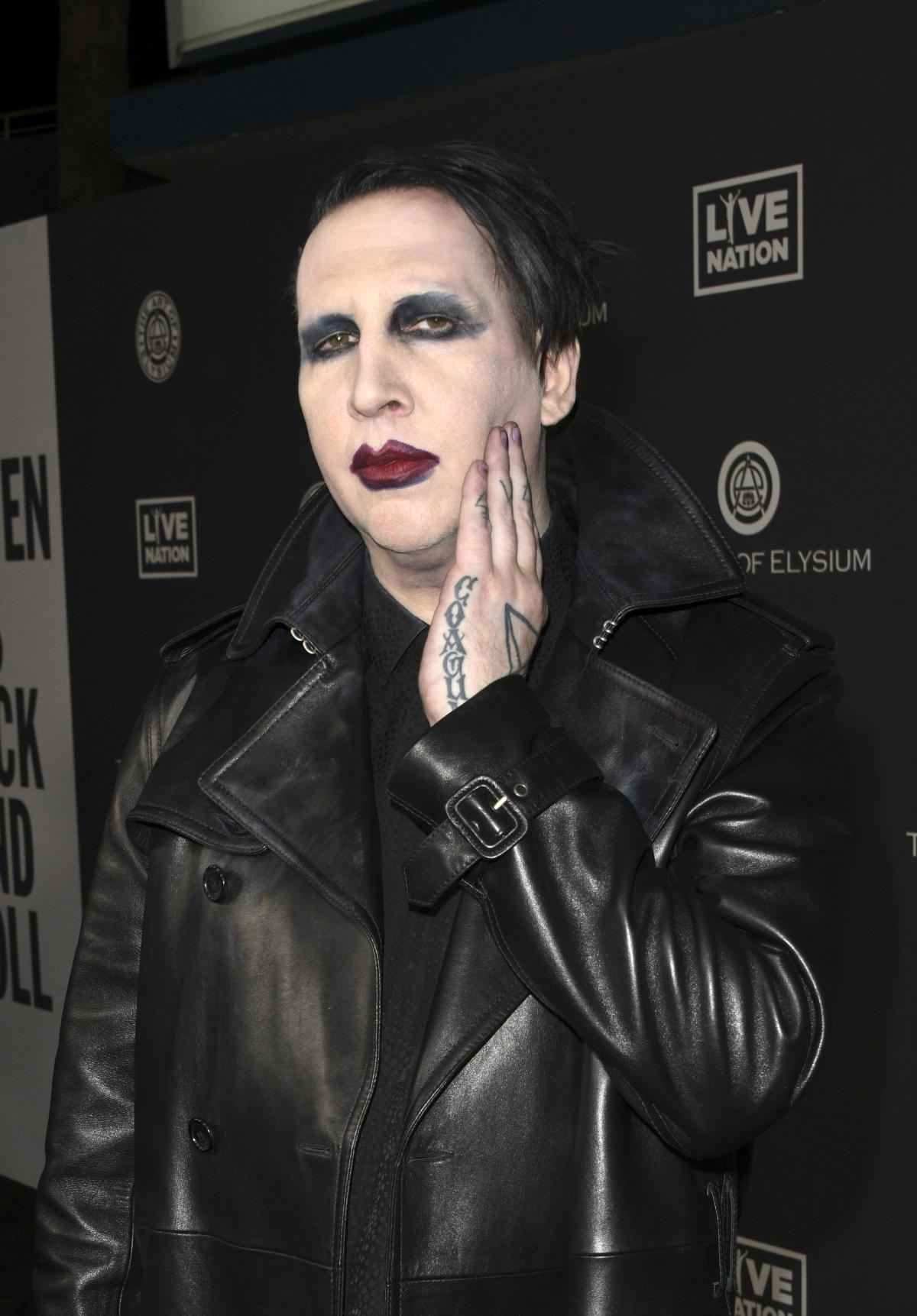 Marilyn Manson fined for blowing nose on concert camerawoman - BBC News