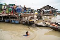 Residents demolish their floating houses on the Tonle Sap river after they were ordered to leave within one week of being notified by local authorities in Prek Pnov district