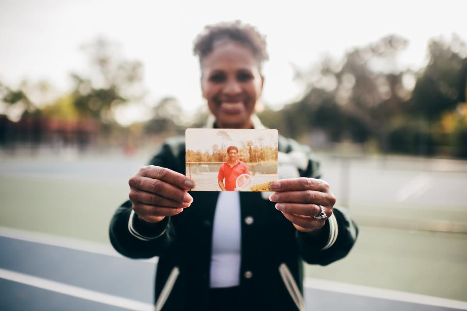 Judge Donna Robinson Milhouse holds a photo of her father, the late Donald Robinson, who is always close to her heart and a primary reason why she earned a tennis scholarship and pursued a law career.