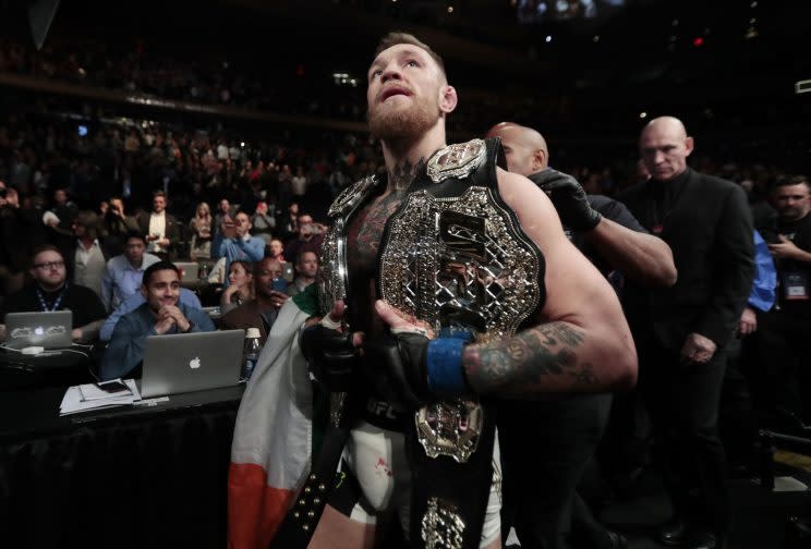 Conor McGregor celebrates after winning the lightweight title at UFC 205. (AP)
